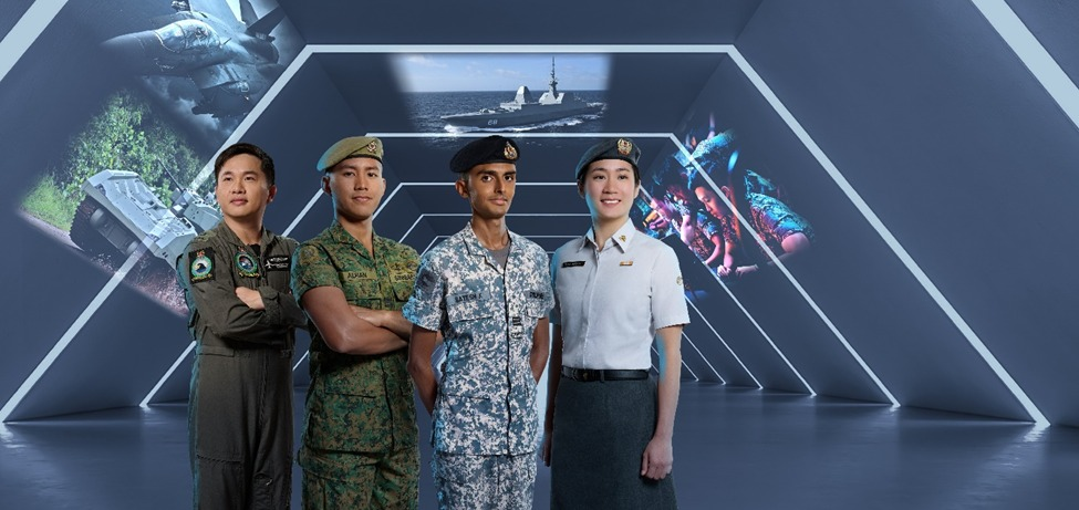 Four individuals in military uniforms, standing together in front of an academic-related backdrop.